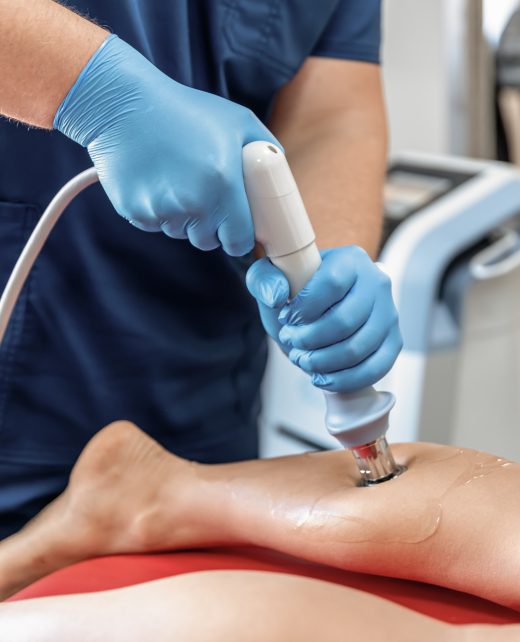 Shock wave therapy, the magnetic field, rehabilitation, physiotherapist doctor performs surgery on a patient's shin.